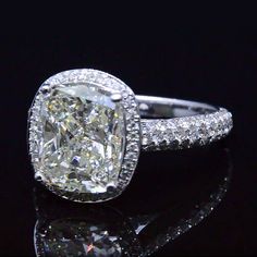 a cushion cut diamond ring with pave set shoulders