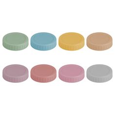 six different colored pill caps on a white background