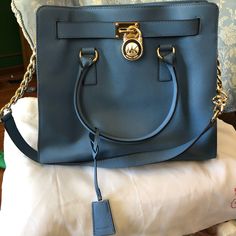 Gently Used, Authentic Michael Kors Baby Blue Bag. Only Blemish Is On The Bottom And It Can Be Cleaned With The Proper Material Cleaner. Comes With White Storage Sack. - Blue Genuine Leather - Beige Mk Signature Fabric On The Inside - Gold Hardware - Snap Closure - Lots Of Compartments - Zipper Pouch - (L) 14 X (H) 12 X (W) 5.5 Inches Michael Kors Baby Bag, White Storage, Blue Purse, Michael Kors Hamilton, Blue Bags, Michael Kors Bag, Zipper Pouch, Gold Hardware, Snap Closure