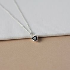 Tiny Heart Charm Necklace - Dainty Black CZ Necklace - Minimalist Everyday Silver Necklace A sweet, dainty necklace to fall in love with! :) This pretty necklace features a tiny cubic zirconia charm bezel set in sterling silver and paired with sterling silver cable chain. The charm is quite tiny at 6mm but it has some subtle sparkle to it. The heart slides freely along the chain for an elegant minimalist design that's perfect for adding a romantic touch to your outfit. The necklace is really ver Dainty Heart Pendant Birthstone Necklace, Minimalist Heart Pendant Charm Necklace With Birthstone, Minimalist Birthstone Heart Pendant Charm Necklace, Dainty Heart-shaped Birthstone Charm Necklace, Minimalist Heart-shaped Birthstone Charm Necklace, Dainty Heart Pendant Birthstone Charm Necklace, Dainty Double Heart Birthstone Necklace, Delicate Heart Charm Necklace With Birthstone, Delicate Heart-shaped Birthstone Charm Necklaces