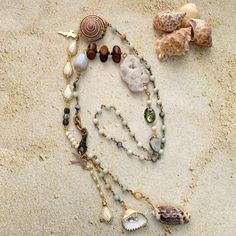 Long seashell necklace filled with a mix of organic beach treasures including wood and seashells along with a polished agate, faux pearls, and shimmering Swarovski rhinestones. Perfect summer necklace to complete your vacation style or give as a gift for beach lovers. This necklace is worn over the head with a long 19" drop.  ~This necklace is made to order. Due to the beauty of nature, and no two organic things being exactly the same, the seashells and natural stones on your necklace may vary s Beach Jewelry With Gemstone Shell Beads, Bohemian Strand Necklace With Starfish Charm, Shell Jewelry With Gemstone Beads For Beach, Ocean-inspired Beaded Necklaces With Natural Stones For Beach, Bohemian Beaded Necklace With Starfish Charm For Beach, Beach Strand Necklaces With Natural Stones, Bohemian Shell Necklace With Starfish Charm, Beach Shell Beaded Necklaces With Natural Stones, Nature-inspired Beach Necklaces With Natural Stones