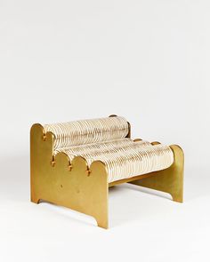 a bench made out of metal and gold colored material on white background with clippings