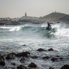 a man riding a wave on top of a surfboard