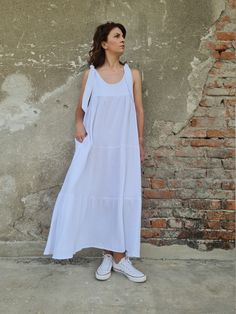 "This long double gauze cotton dress (muslin) has wide strings so you can regulate the length and three layers. Ideal for the summer days and nights either in the city or beach side. Two side pockets. You can also be creative and have your own color combination. ✥ Welcome to my world! I create my design in my dreams and I draw geometric lines and extravagant patterns with scissors, needles and thread. Be my dream catcher and let me create for you a parallel fashion world! ✥ SHIPPING Express ship White Sleeveless Summer Dress With Tie Straps, Sleeveless Cotton Gauze Dresses For Daywear, Flowy Sleeveless Linen Dress For Daywear, White Cotton Gauze Summer Dress, White Cotton Gauze Spring Dress, White Cotton Gauze Dress For Spring, White Summer Maxi Dress With Tie Straps, Breezy Sleeveless Cotton Maxi Dress, White Sleeveless Maxi Dress With Tie Straps