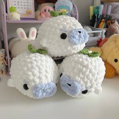 crocheted stuffed animals sitting on top of a table