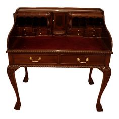 an antique wooden desk with two drawers