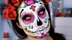 a woman with makeup painted to look like a skull and roses in her hair, wearing a flower crown