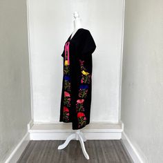 This hand-woven two panel Mexican Yalalag Hupil long tunic is a VINTAGE CLASSIC with flowers embroidered by hand by artisans of Oaxaca 100% handmade. A relaxed style and at the same time looks very elegant for a party in the morning or afternoon. It is made of 100% cotton blanket fabric. MADE IN MEXICOBy: Mexican ArtisansFor: Women Size: M/L Color: black | multi Length: 41.5" Details: Material: cotton silk Non-stretch Embroidered thread Front & back tassels Ankle Length Washing Instructions: Ple Long Folk Style Embroidered Dress, Blanket Fabric, Flowers Embroidered, Cotton Blanket, Long Tunic, Cotton Blankets, Relaxed Style, Clothes Pins, Cotton Silk