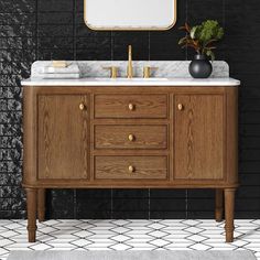 a bathroom vanity with two sinks and a mirror on the wall next to black tiled walls