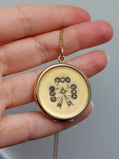 "Introducing an exquisite antique locket, a timeless piece that embodies the grace and charm of the Edwardian era. At the front of the locket is a graceful bow design, decorated with glass rhinestones, adding a subtle sparkle and a touch of femininity and sophistication. The back is plain and could be engraved. Details: The locket is from the 1910s. It is not stamped for gold content and likely made of gold filled. Inside the maker marks are present on the two rings \"J.M.F. & Co\". Condition: The locket has no dent and is in excellent antique condition. It opens from the top, and shuts tightly with a snap. This listing is for the locket only without a chain. Measurements: -Locket diameter : 31mm / 1 1/4\" -Locket height including the jump ring: 40mm / 1 9/16\" Please note that I don't acc Luxury Antique Gold Locket Necklace, Antique Round Necklace With Diamond Accents, Antique Necklace With Diamond Accents, Antique Necklaces With Diamond Accents, Victorian Medallion Jewelry For Vintage Events, Victorian Diamond Medallion Jewelry, Antique Charm Necklaces For Wedding, Victorian Charm Necklaces For Wedding, Elegant Diamond Locket Necklace