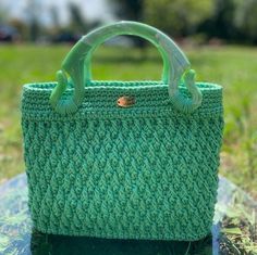 A green jewel that shines your style.With its ideal size,  "Esmeralda" provides ample space for your essentials, making it a safe choice for women seeking both style and functionality! Esmeralda is a crochet bag in green, featuring textured filaments that add a unique touch to its artisanal beauty.  Its resin handles are particularly distinctive, while the inner lining boasts a green patterned fabric that adds a lively flair. T he rigid green faux leather bottom provides structure to the bag. Me Green Square Crochet Bag As Gift, Green Square Crochet Bag For Gift, Green Top Handle Crochet Shopping Bag, Green Rectangular Crochet Bag, Green Top Handle Crochet Bag For Shopping, Green Crochet Top Handle Bag For Shopping, Handmade Green Rectangular Bag, Green Rectangular Crochet Bag For Daily Use, Green Crochet Bag For Daily Use