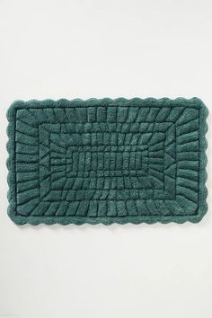 a green bath mat on a white background