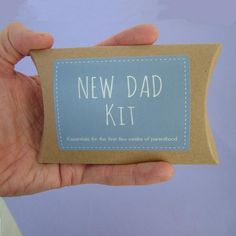 a person holding a new dad kit in their left hand with the label on it