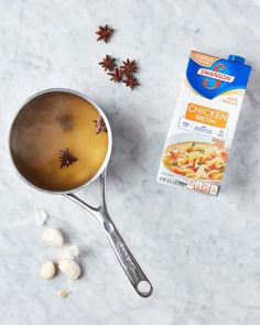 ingredients to make chicken chow in a saucepan and spoon on a marble counter top