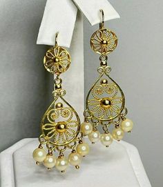 "Gorgeous vintage chandelier earrings! Pair of Marked 750 (18K) yellow gold saltwater cultured pearl chandelier style pierced earrings. Attached to the earrings are well made leverback style earring fasteners, designed to match the chandelier earring. Each saltwater cultured pearl measures approximately 4.80 mm x 4.80 mm. Each earring measures approximately 1 3/4\" long x 3/4\" wide. The pair of 18K yellow gold pearl earrings weigh 8.90 grams. The beautiful chandelier style earrings come in a qu Ornate Yellow Gold Dangle Chandelier Earrings, Ornate Yellow Gold Chandelier Dangle Earrings, Classic Yellow Gold Chandelier Earrings, Ornate Hallmarked Dangle Chandelier Earrings, Ornate Hallmarked Chandelier Dangle Earrings, Yellow Gold Pearl Drop Dangle Chandelier Earrings, Elegant Filigree Dangle Pearl Earrings, Formal Yellow Gold Chandelier Earrings With Pearl Drop, Classic Filigree Dangle Chandelier Earrings