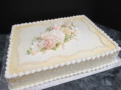 a cake with white frosting and flowers on it