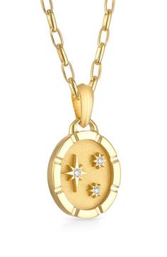 Dainty diamonds twinkle within a sandblasted oval pendant on a celestial necklace crafted from polished 18-karat yellow gold. 18" length; 2" extender; 7/8" diameter pendant Total diamond weight: 0.04ct. Color: G–H Clarity: VS 18k gold/diamond Made in the USA >Diamond Guide Yellow Gold Medallion Necklaces With Star Charm, Yellow Gold Medallion Necklace With Star Charm, Luxury Celestial Oval Pendant Necklace, Delicate Star-shaped Yellow Gold Necklace, Celestial Star-shaped Yellow Gold Necklace, Second Star To The Right, Oval Pendant Necklace, Celestial Necklace, Diamond Guide