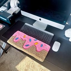 a computer desk with a cake on it