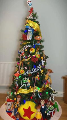 a christmas tree with many toys around it