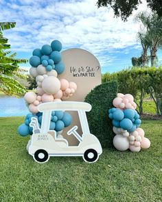 a golf cart with balloons on the grass