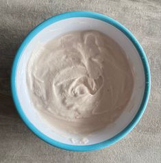 a blue and white bowl filled with cream