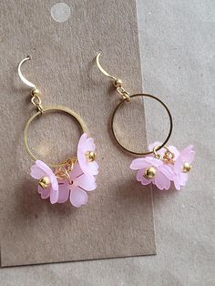 These sweet floral earrings feature delicate flowers grouped together and suspended from a brass link. The effect is delicate and pretty, and of course somewhat demure. Please message me for the color variation. Flower Wire Earrings, Delicate Flower Charm Earrings For Spring, Delicate Dangle Earrings For Spring, Handmade Feminine Dangle Flower Earrings, Dainty Dangle Earrings For Spring, Spring Dainty Dangle Earrings, Dainty Spring Dangle Earrings, Gold Feminine Flower Earrings With 3d Flowers, Dainty Flower Earrings With 3d Flowers