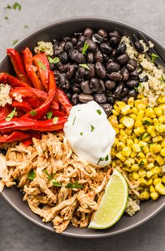 a bowl filled with black beans, corn and other foods