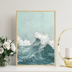 a painting on a shelf next to a vase with white flowers and a lit candle