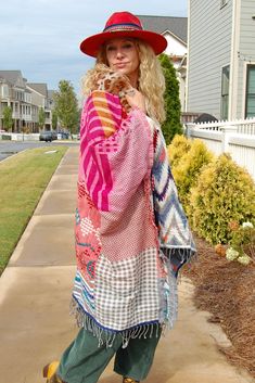 The Noble Balance Poncho in Rose/Blue Combo ♡ Product Highlights ♡ This Noble Balance Poncho in Rose/Blue Combo is the perfect statement and stylish layering piece to add to your closet, and or any on-trend bohemian style outfit! Giving your look a trendy element, this poncho makes a statement with its beautiful multi colored knit and crocheted pattern, a faux fur neck lining, and trendy tassels! This beautiful and luxurious poncho is the perfect piece for the transitional fall to winter season! ✁ Contents & Measurements ✁ This Noble Balance Poncho contains 65% Acrylic, 33% Viscose, and 2% Wool material. Total body length (shoulder to bottom) measures to 45 inches. Bust measurements are 40.5 inches! Measured from one size. For reference the model, and owner Spirit, is wearing one size. Her Pink Patchwork Outerwear For Summer, Summer Pink Patchwork Outerwear, Pink Bohemian Outerwear For The Beach, Bohemian Pink Outerwear For The Beach, Bohemian Pink Outerwear For Beach, Pink Bohemian Outerwear For Beach, Pink Outerwear For Fall Vacation, Oversized Bohemian Pink Outerwear, Oversized Pink Bohemian Outerwear