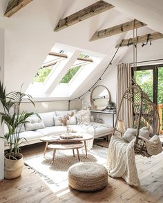 a living room filled with furniture and lots of windows in the skylight above it