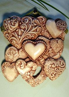 an intricately decorated heart shaped broochle on a table