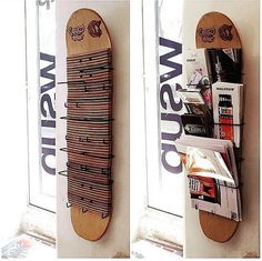 two skateboards mounted to the side of a wall next to a window with advertisements on it