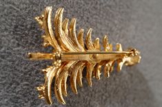 I am offering this fabulous yellow gold tone brooch. This piece is truly gorgeous, and it has the following features: * beautiful vintage pin * rhinestone * glass stone * holiday theme * christmas tree * 2 inches in length This is a fantastic and classic piece. There is tons of sparkle and shine with this piece. It will beautifully complement your upcoming fashion season. Buyer pays all shipping and handling. Elegant Gold Brooches For Christmas, Elegant Gold Christmas Brooches, Gold Holiday Brooch Jewelry, Gold Brooches For Formal Christmas Occasion, Gold Christmas Brooches For Formal Wear, Theme Christmas Tree, Frog Design, Holiday Theme, Stud Style