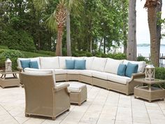 an outdoor patio furniture set with blue and white pillows