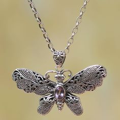 A beautifully ornate sterling silver butterfly with scroll and dot motifs in its wings hangs from a bold sterling silver cable chain in this pendant necklace presented by Putu Putri of Bali. A faceted oval of amethyst sparkles from the center of the butterfly's body. Silver Butterfly Filigree Jewelry, Silver Filigree Butterfly Jewelry, Silver Spiritual Jewelry With Butterfly Charm, Spiritual Silver Jewelry With Butterfly Charm, Sterling Silver Butterfly Necklace, Amethyst Pendant Necklace, Amethyst Necklace Pendant, Butterfly Pendant Necklace, Silver Feather