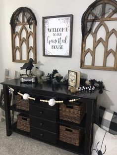 a black dresser with baskets and decorations on it