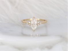 a diamond ring sitting on top of a white furnish