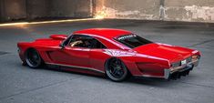 a red sports car is parked in an empty parking lot with no one around it