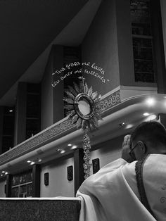 a man sitting in front of a church alter