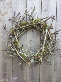 a wreath made out of branches and moss