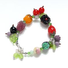 This bright and unusual Glass berry lampwork bracelet are made with love to Nature. It's good for everyday outfits and for special occasions. This bracelet fits a 16-17.5cm diameter wrist. If you need bigger or smaller size bracelet, please, write me the diameter of your wrist when making an order. Dimentions: 21cm. Materials: artist lampwork beads, metal fittings. Colors used: red, orange, yellow, green, violet. Please, note, each lampwork bead is made by hand and may differ slightly. All the p Playful Jewelry With Fruit Design For Gift, Playful Fruit Design Jewelry For Gifts, Cute Berry Colored Jewelry With Fruit Design, Cute Berry-colored Jewelry With Fruit Design, Cute Berry-colored Fruit Design Jewelry, Jewelers Making, Berry Bracelet, Splatoon Oc, Kawaii Bracelet