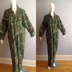 Loving This Vintage Camouuflage Boiler Suit OVERSIZE VIBE Versatile, Comfortable, Gender Neutral Jumpsuit Step In Zipper Front  Utility Pockets Excellent Vintage Condition Label: World Famous Camouflage Suit Fabric Content:  100% Cotton Tag Reads Size XL Oversize, Baggy Fit Please Refer To Measurements To Ensure Proper Fit Excellent Vintage Condition With Jumpsuit lying flat in inches: Shoulders: 20 Underarms: 23 Waist: 21 Hips: 24 Inseam of Arm: 22 Top of Shoulder To Crotch: 34 Inseam of Leg:  31 Military Style Cotton Overalls, Military Style Khaki Jumpsuit, Military Style Long Sleeve Cotton Jumpsuits And Rompers, Military Style Long Sleeve Cotton Jumpsuit, Military Style Long Sleeve Khaki Jumpsuit, Khaki Military Long Sleeve Jumpsuit, Khaki Military Style Long Sleeve Jumpsuits, Military Style Jumpsuits And Rompers With Pockets, Neutral Jumpsuit