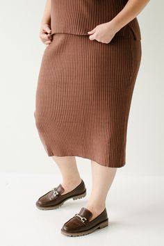 Flattering, modest, and possibly the most comfortable skirt you will ever own, the plus 'Delaney' sweater skirt is perfect to transition into fall with! The skirt features an elastic waistband, is a midi length, and made out of a soft ribbed material. Pair it with the plus 'Delaney' sweater top for a cozy set outfit! 50% Viscose, 28% Polyester, 22% Nylon Hand Wash Cold Hang or Lay Flat to Dry Do Not Bleach Unlined FINAL SALE: NOT ELIGIBLE FOR RETURN OR EXCHANGE Model Height 5'8" | Wearing Size 3 Cozy Set Outfit, Midi Sweater Skirt, Comfortable Skirts, Layered Tops, One Inch, Set Outfit, Skirt Leggings, Blouse Dress, Tops For Leggings