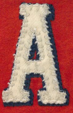 the letter a is made out of yarn