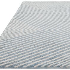 a blue and white striped rug on a white surface with lines drawn across the top