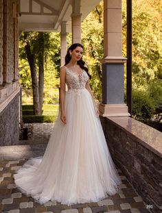 a woman in a wedding dress standing on a porch