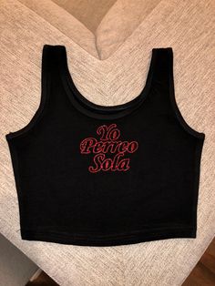 "Super cute bad bunny crop top with \"yo perreo sola\" letters in \"EUTDM\" font super cute for bad bunny's concert or for a gift ! These shirts are pressed professionally so the glitter does not fall off ! ✨ ** DISCLAIMER shirts have a snug fit so if in doubt size up !" Fitted Slogan Crop Top For Streetwear, Casual Crop Top Tank For Streetwear, Black Band Merch Crop Top For Summer, Black Cotton Band Merch Crop Top, Summer Band Merch Crew Neck Crop Top, Band Merch Crew Neck Crop Top With Letter Print, Fitted Band Merch Crop Top For Streetwear, Y2k Streetwear Cropped Crop Top, Y2k Cropped Crop Top For Streetwear