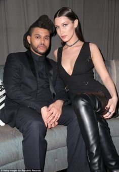 a man and woman are sitting on a couch