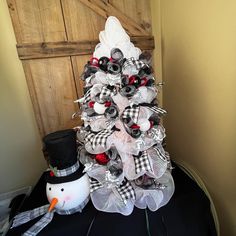 a white christmas tree with black and red decorations