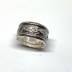 Here is a chunky, wide sterling silver which features a deeply etched floral middle section flanked by classic half-round sterling wires for a ring that it one part antique style and one part modern bohemian!  This ring is 7/16" wide (nearly 1/2"), and will be custom sized up to a 10. Makes a classic band ring, or a great thumb ring, too!  💎 Prefer a narrower but still chunky ring? Here is one with tanzanite: https://www.etsy.com/listing/1753538571/tanzanite-sterling-silver-ring-victorian?ref=l Stamped Sterling Silver Wide Band Jewelry, Silver Sterling Silver Engraved Wide Band Ring, Elegant Wide Band Stamped Jewelry, Adjustable Engraved Silver Wide Band Ring, Heirloom Silver Ring With Thick Band, Adjustable Wide Band Engraved Ring, Vintage Silver Wide Band Ring, Silver Heirloom Wide Band Jewelry, Silver Artisan Engraved Ring For Anniversary